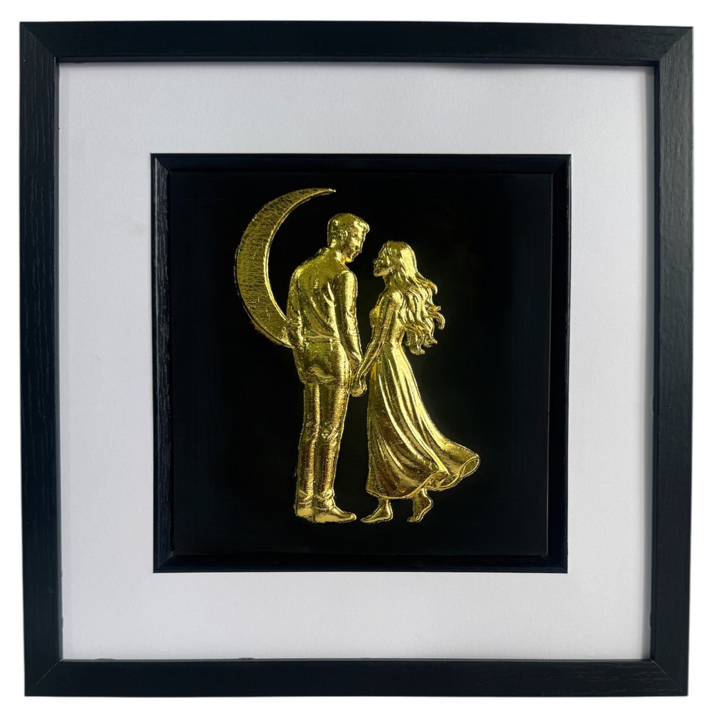 Front-facing gold leaf couple under crescent moon wall art centred on a black background