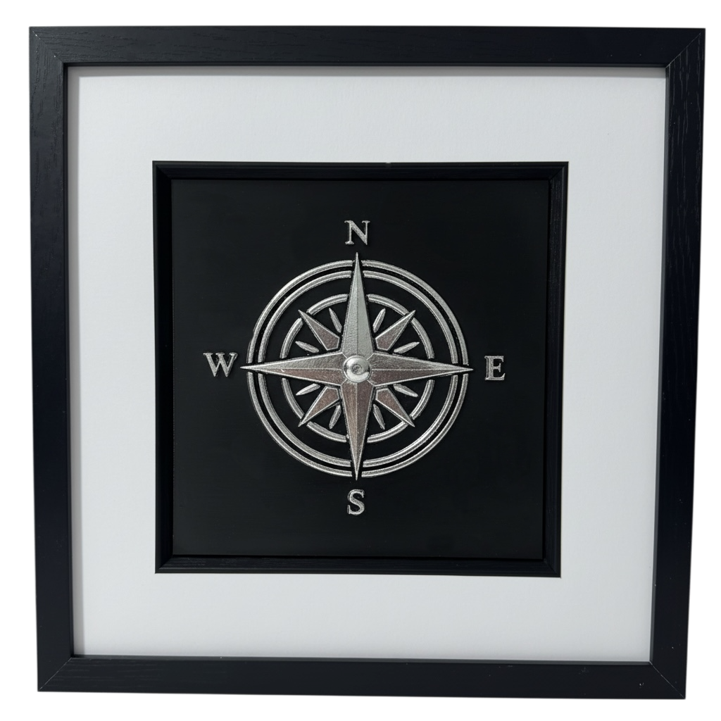Silver compass rose wall art framed as a retirement gift in raised relief with black frame and white mount