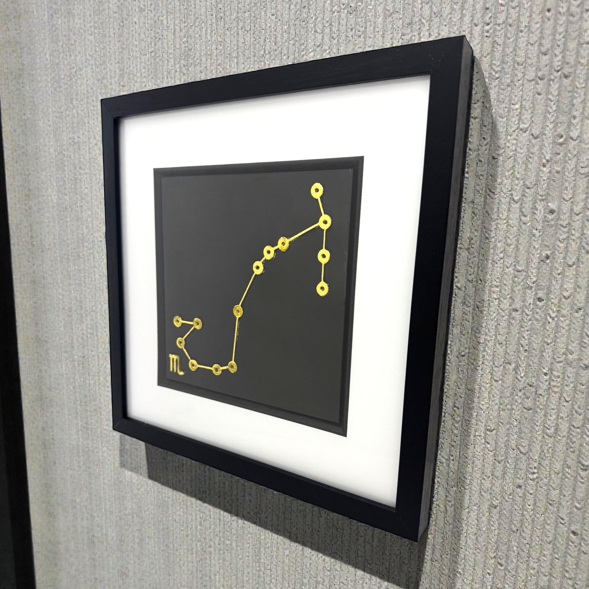 Scorpio constellation wall art displayed on wall in black frame