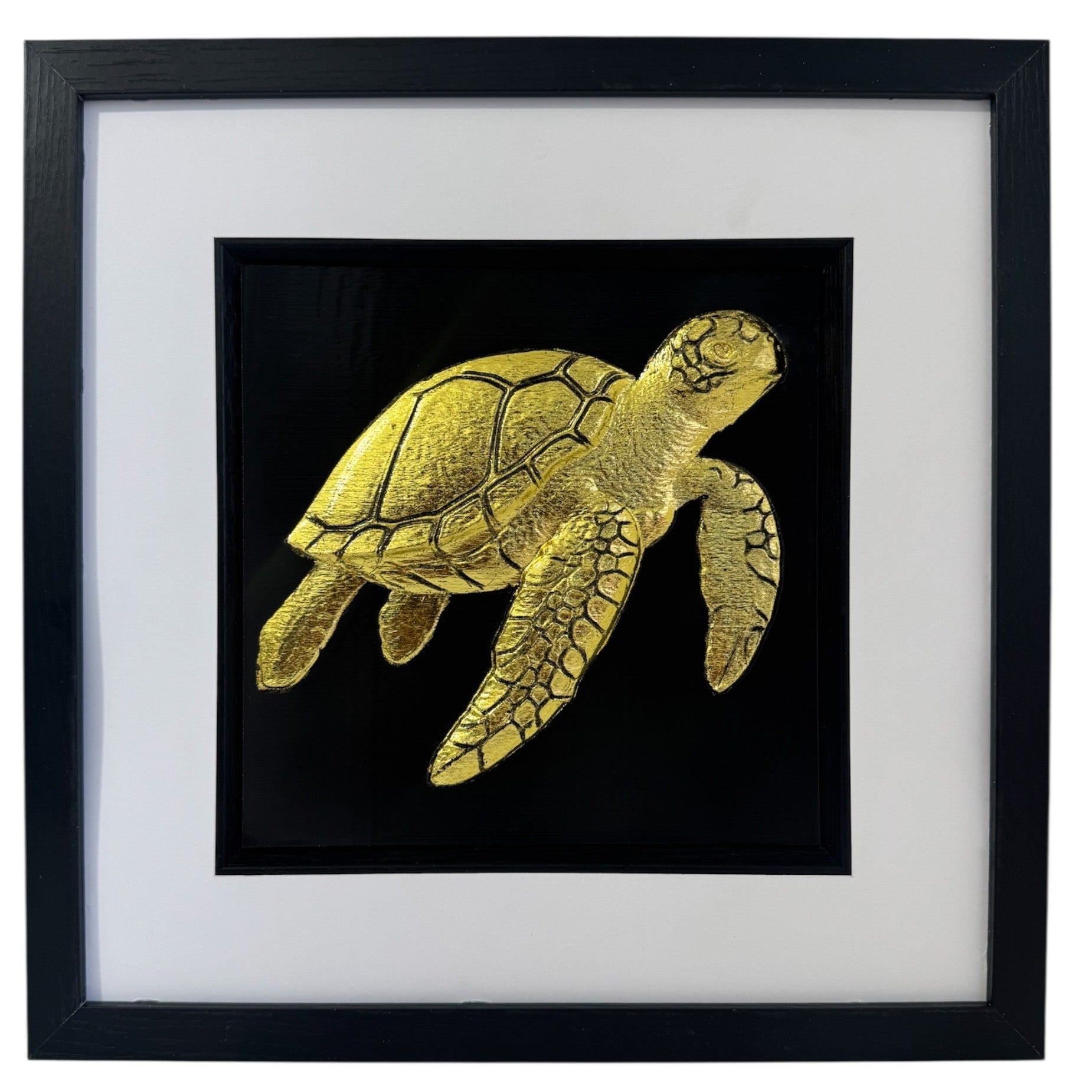 Gold framed sea turtle relief on a black background with a wide white mount and black inner surround