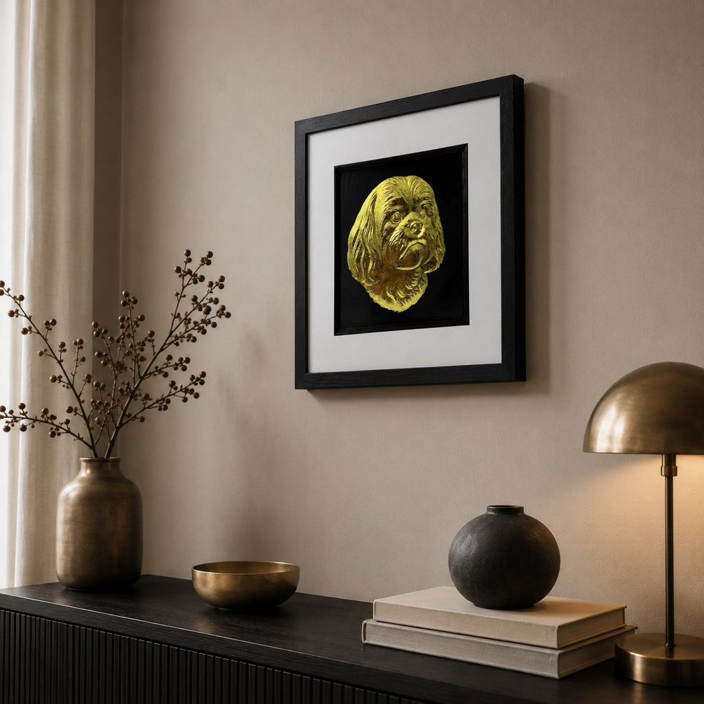 Angled view of Shih Tzu gold leaf framed dog wall art styled in a modern home interior with black frame, white mount, and luxury gold accents.