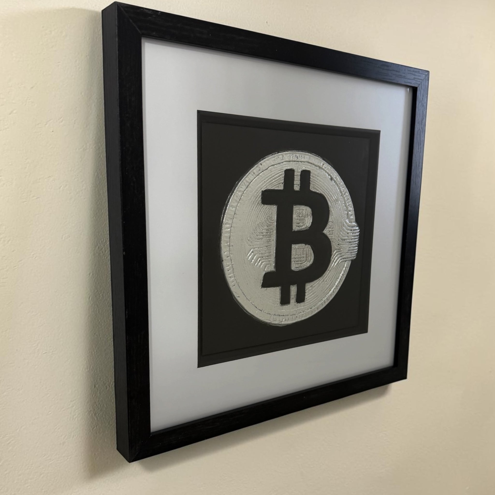 Side view of Bitcoin silver leaf wall art with white mount