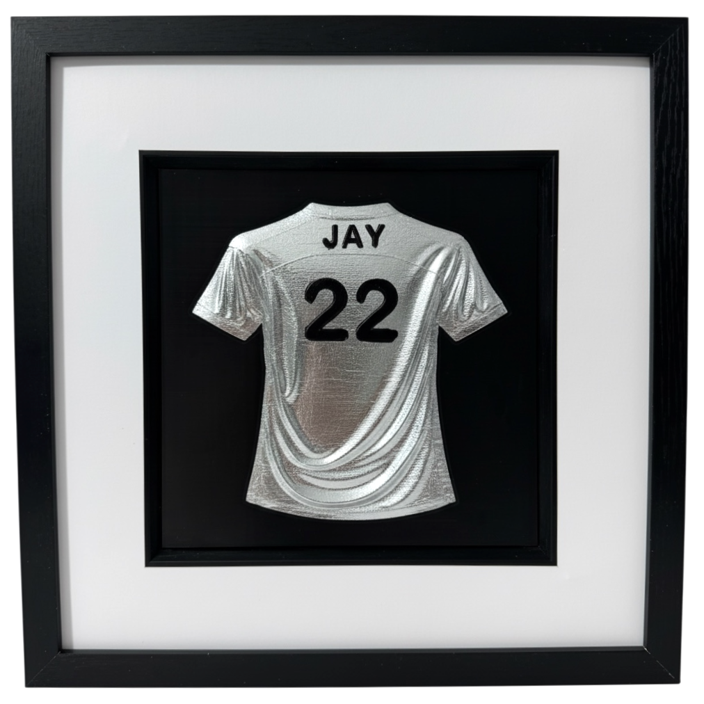 Silver 3D relief football shirt framed wall art, personalised with name JAY and number 22, black frame with white mount.