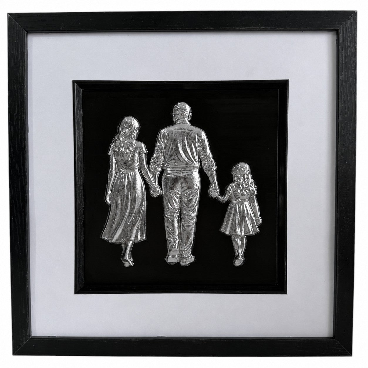 Silver framed family relief artwork showing adult man, woman and child holding hands on black background.