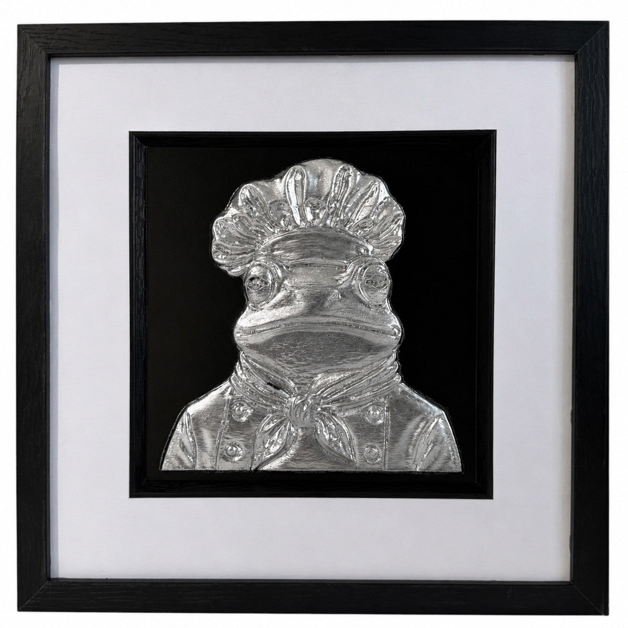 Silver frog chef raised relief framed with white mount, black inner surround and glass front