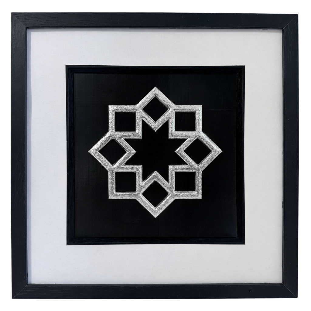 Silver framed Islamic geometric 8 point star relief on a black background with a wide white mount and black inner surround