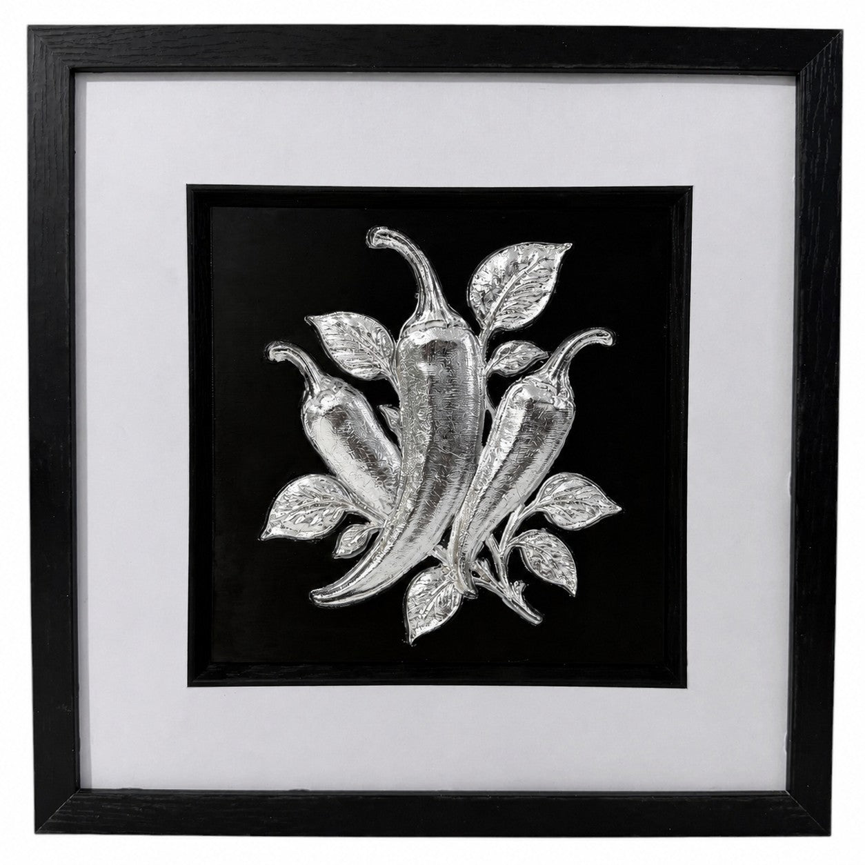 Silver chilli pepper framed relief artwork with glass front, black centre panel and wide white mount.