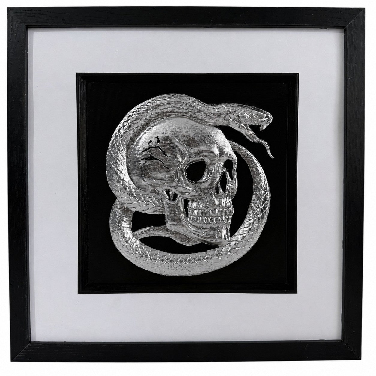 Silver framed skull wall art with raised serpent relief, black centre, white mount and black square frame.