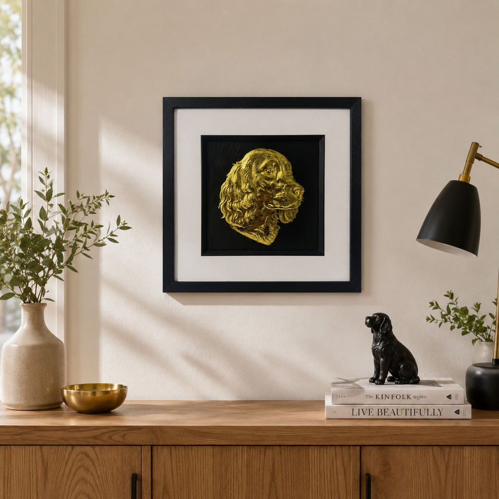 Springer Spaniel gold leaf 3D wall art in a black square frame, styled on a neutral wall above a wooden sideboard with warm home decor accents.