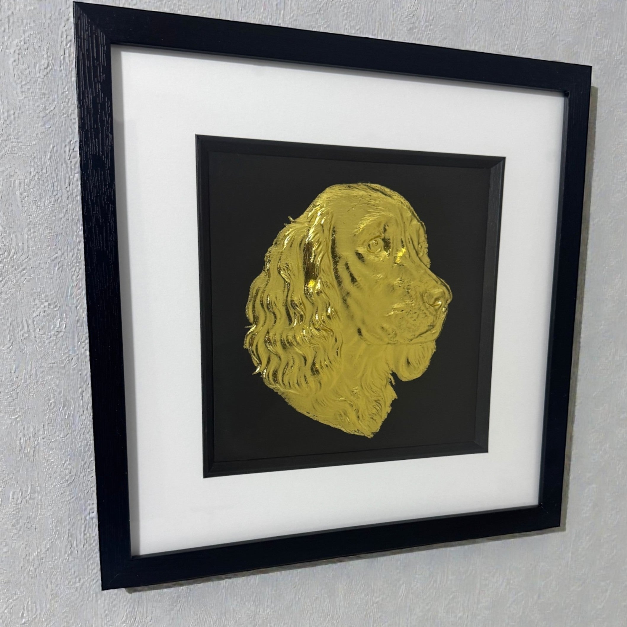 Gold springer spaniel wall art framed and mounted on a light grey wall at an angle