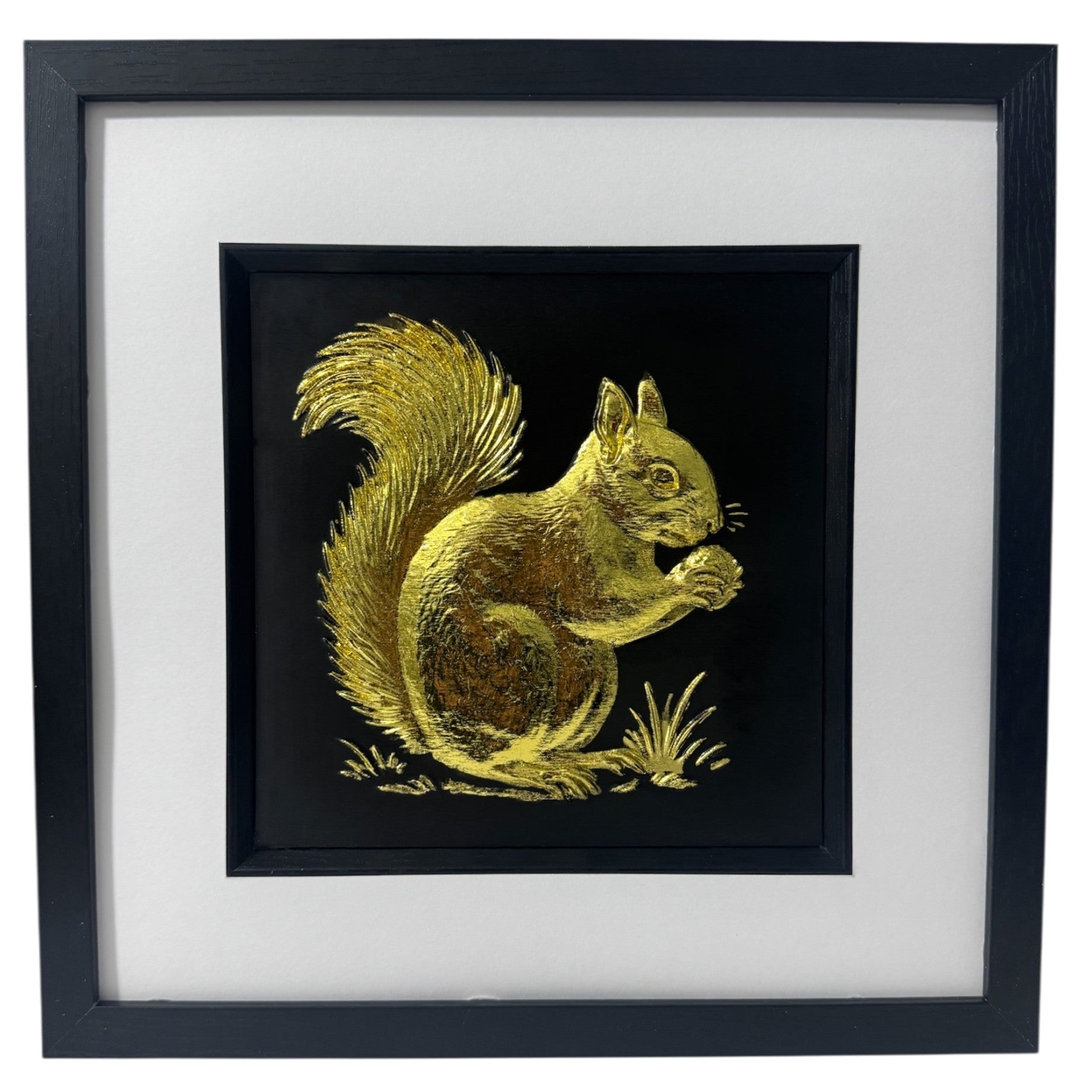Red squirrel 3D wall art in gold leaf, framed in a black wooden frame with white mount on a black background.