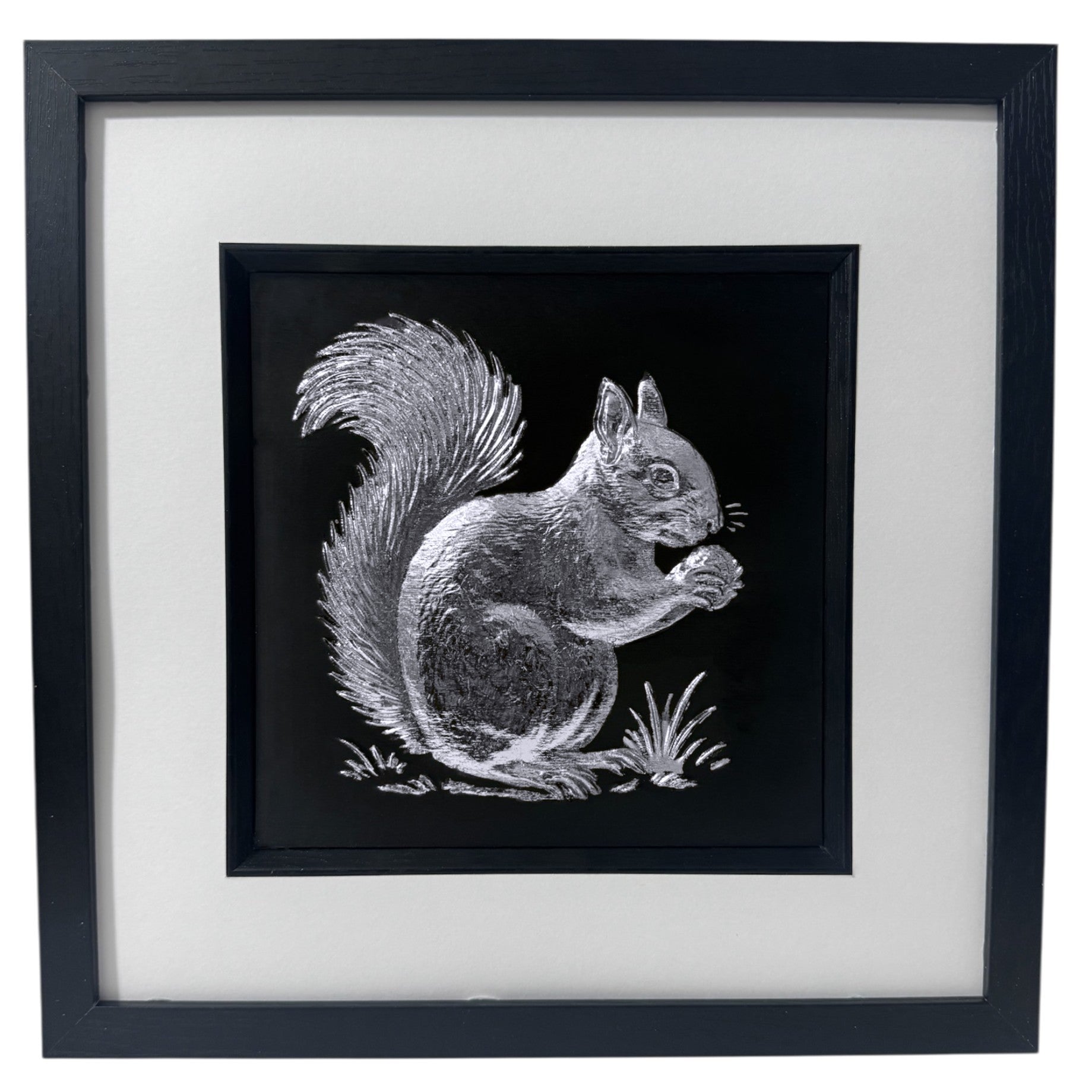 Red squirrel 3D wall art in silver leaf, framed in a black wooden frame with white mount on a black background.