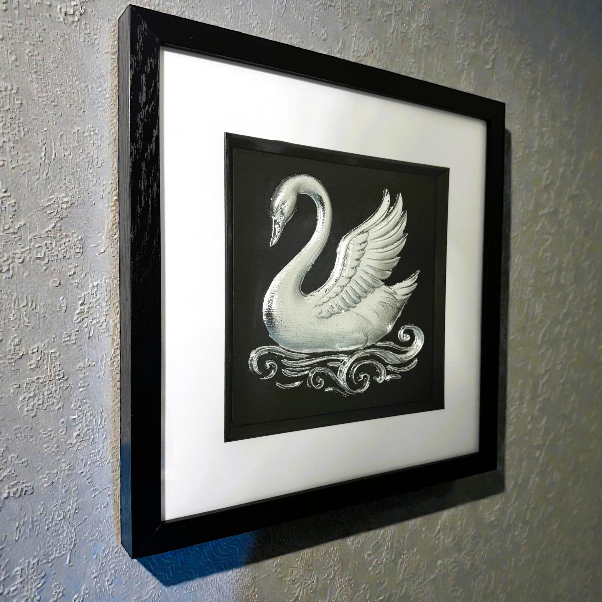 Framed swan wall art shown from an angled wall view