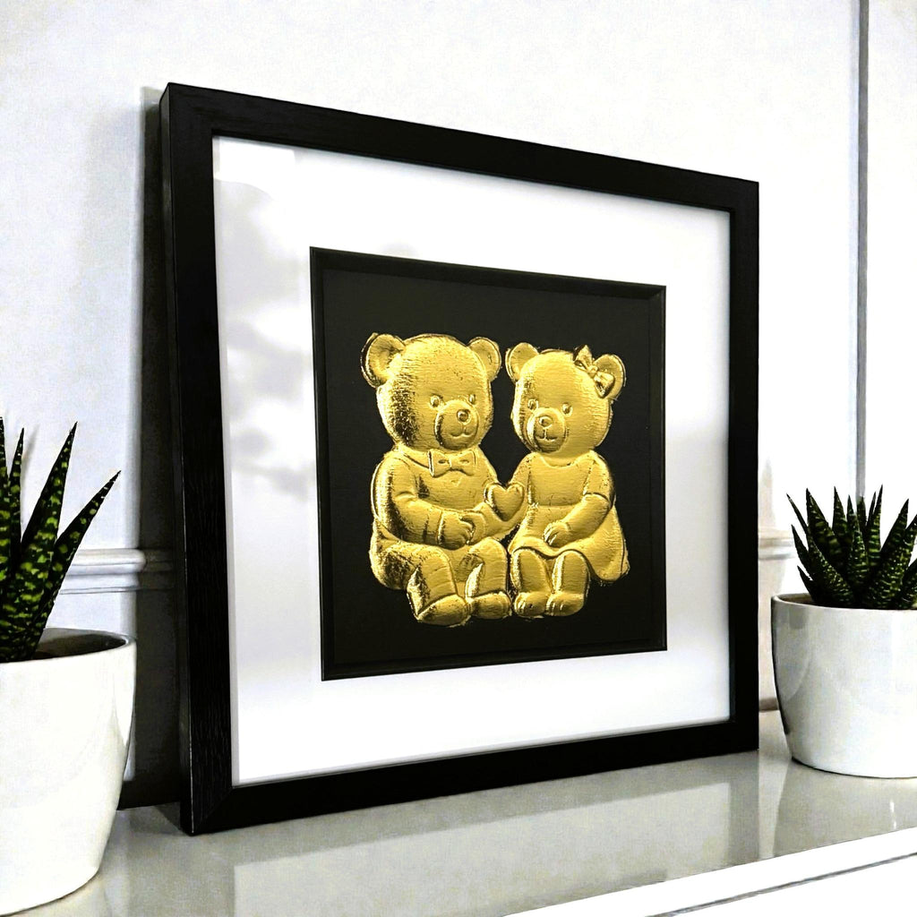 Angled view of teddy bear couple framed wall art on a shelf