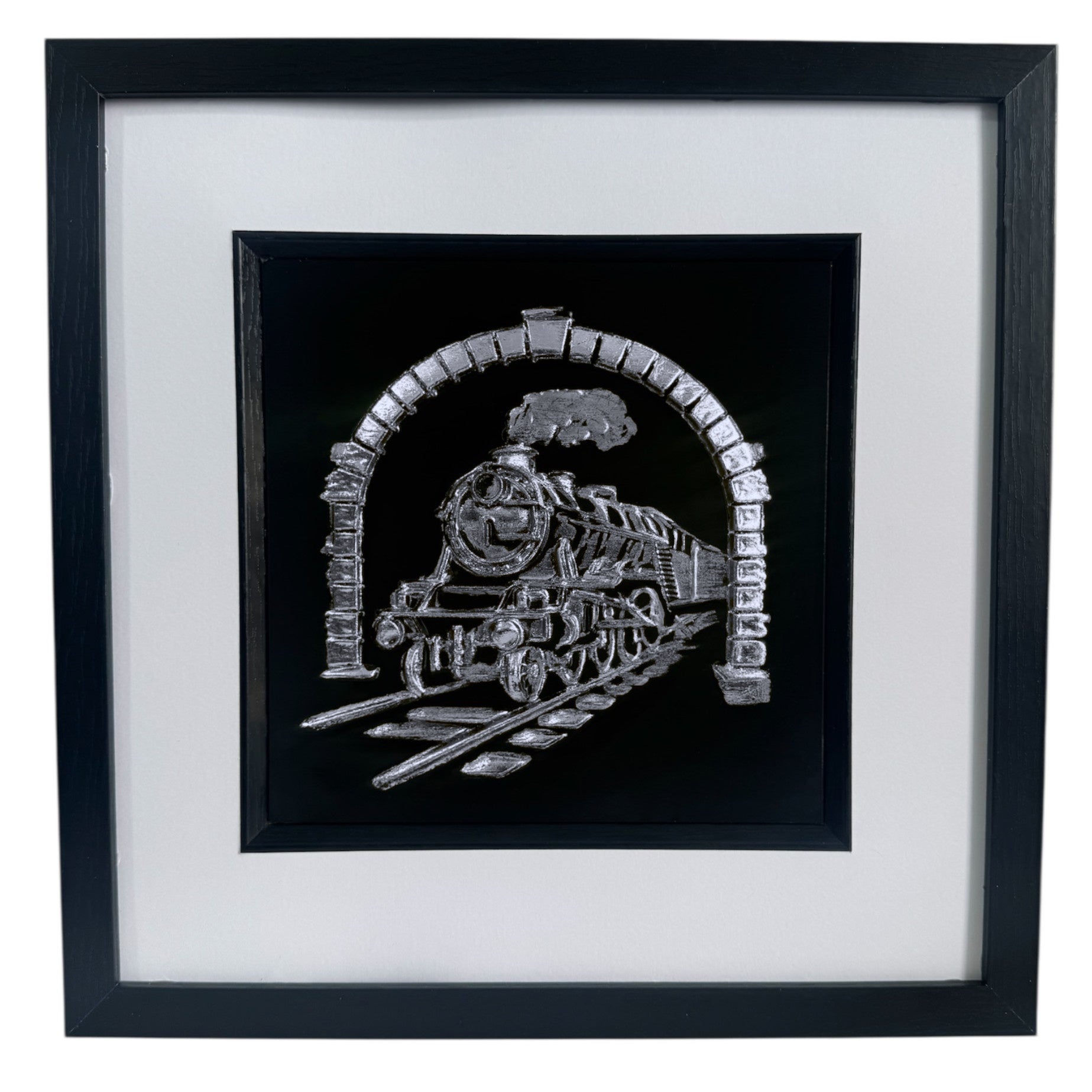 Front view of steam locomotive relief artwork in Silver Leaf on black background with white mount in a black box frame