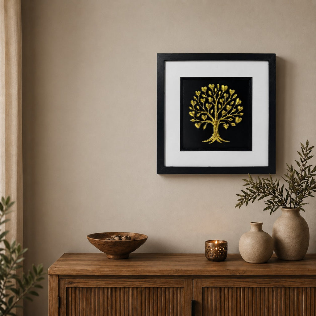 Gold tree of life framed wall art displayed on a warm neutral wall above a wooden sideboard with natural decor and soft candlelight.