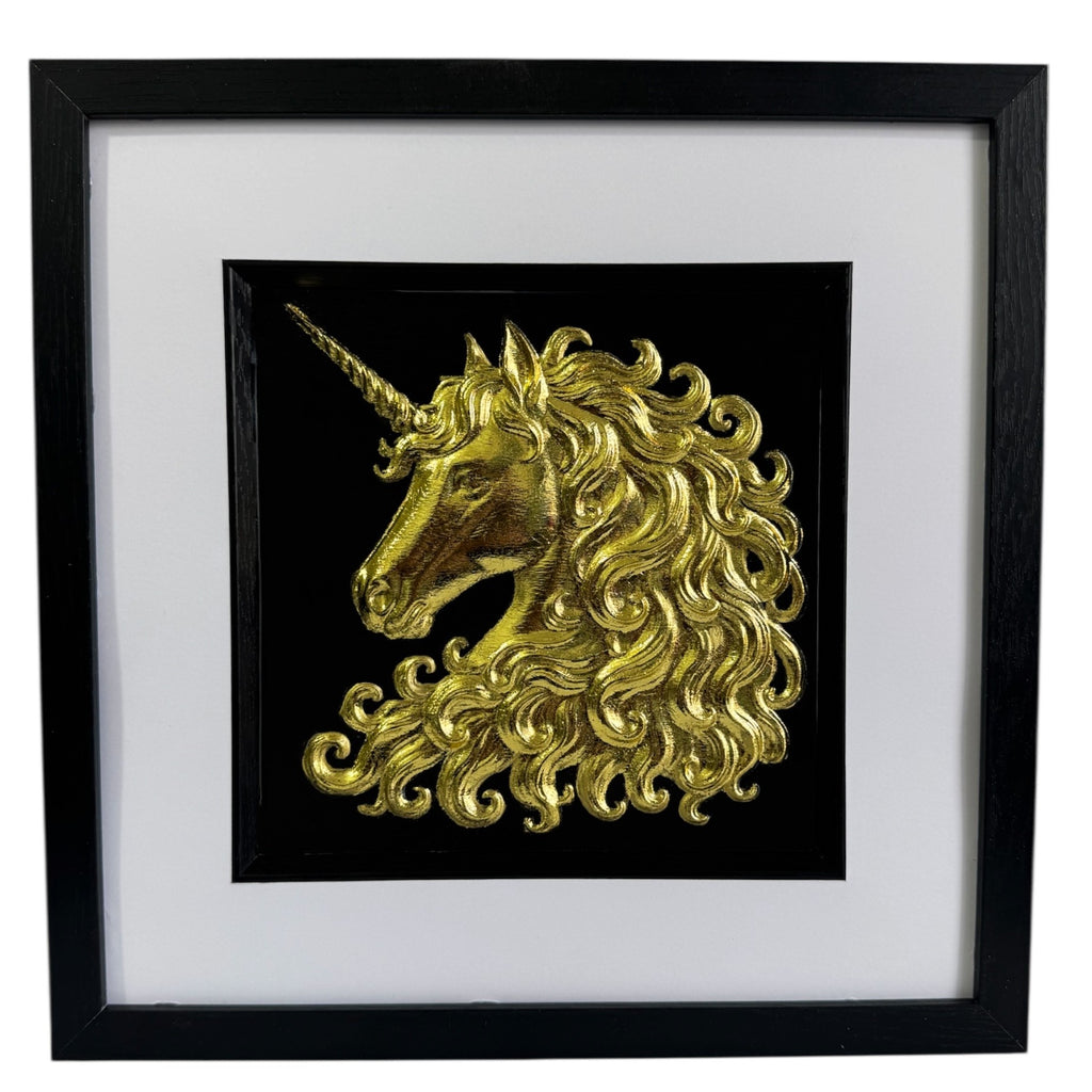 Framed unicorn wall art in gold leaf with raised relief unicorn head on a black background, black frame with white mount