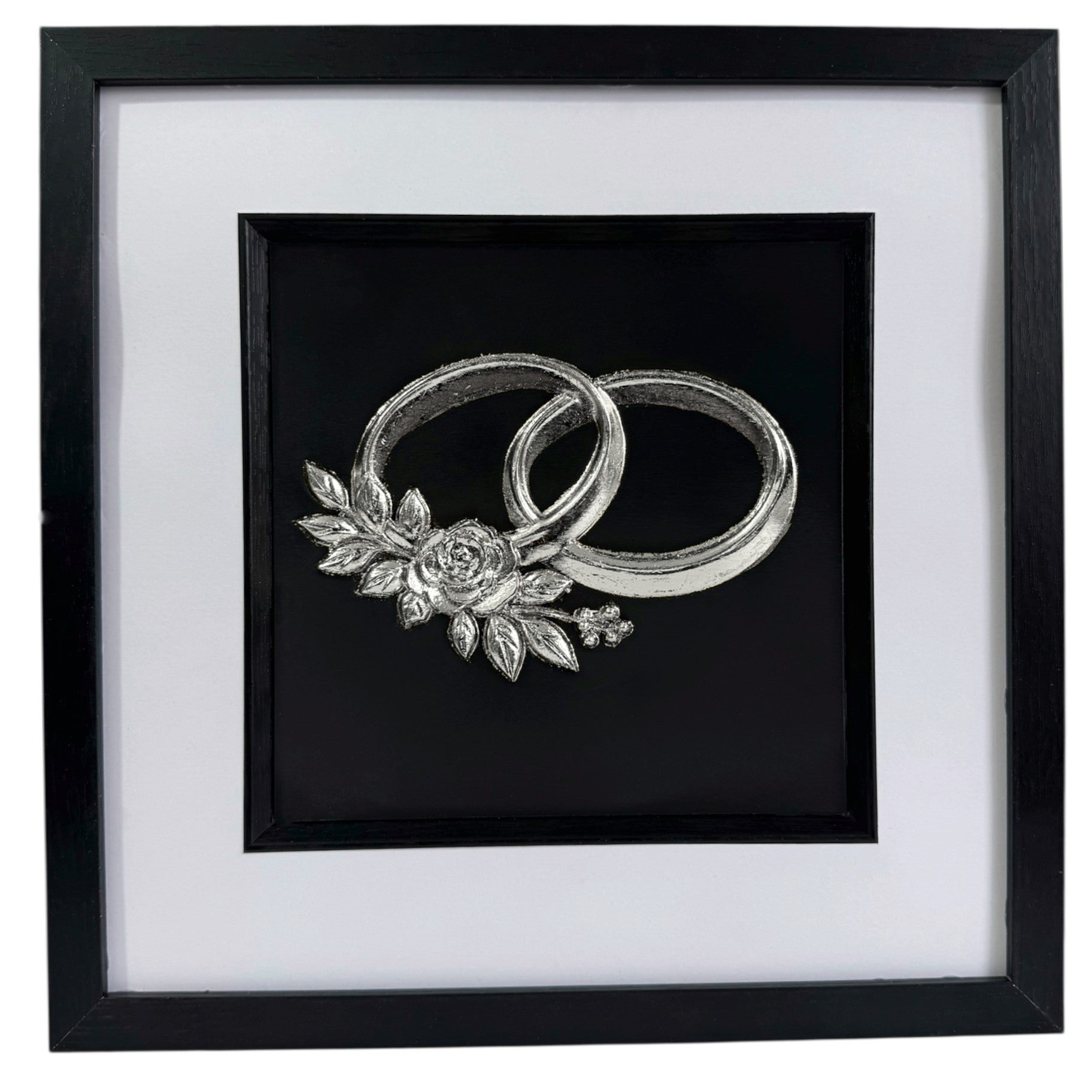 Front-facing silver leaf wedding rings wall art centred on a black background