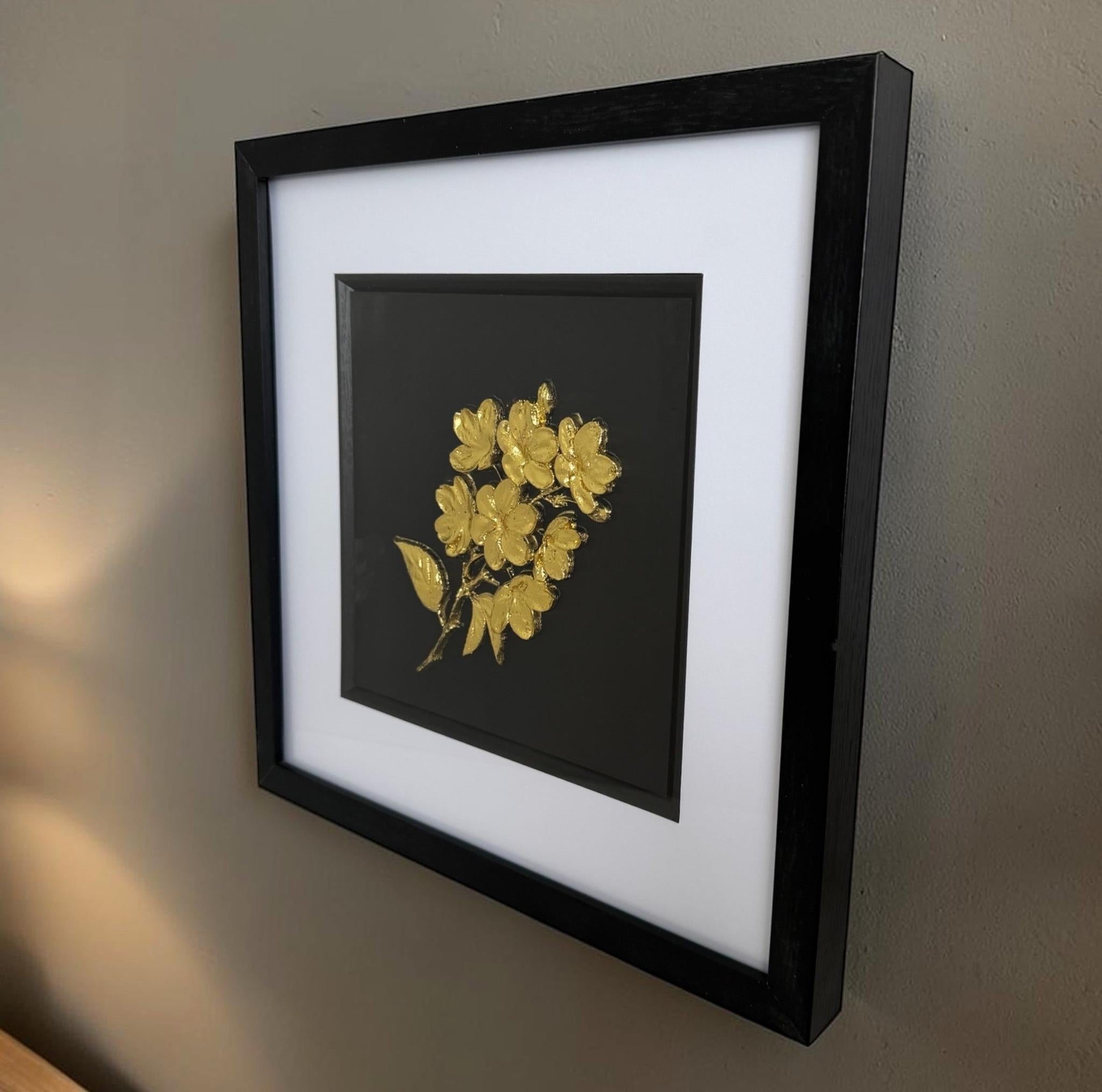 Ready to hang gold 3D flower bouquet artwork in a black box frame on a warm neutral wall, with fitted hanging fixings on the back