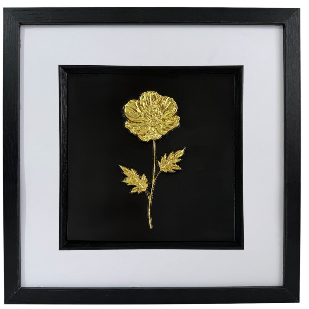 Gold framed flower wall art with raised wildflower relief, black centre, white mount and black frame.