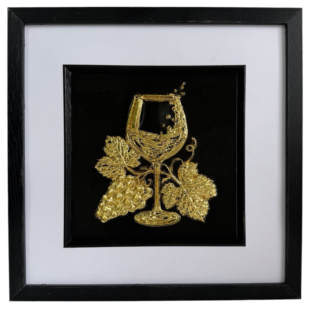 Gold wine glass and grape raised relief artwork in a black frame with white mount and black inner surround.