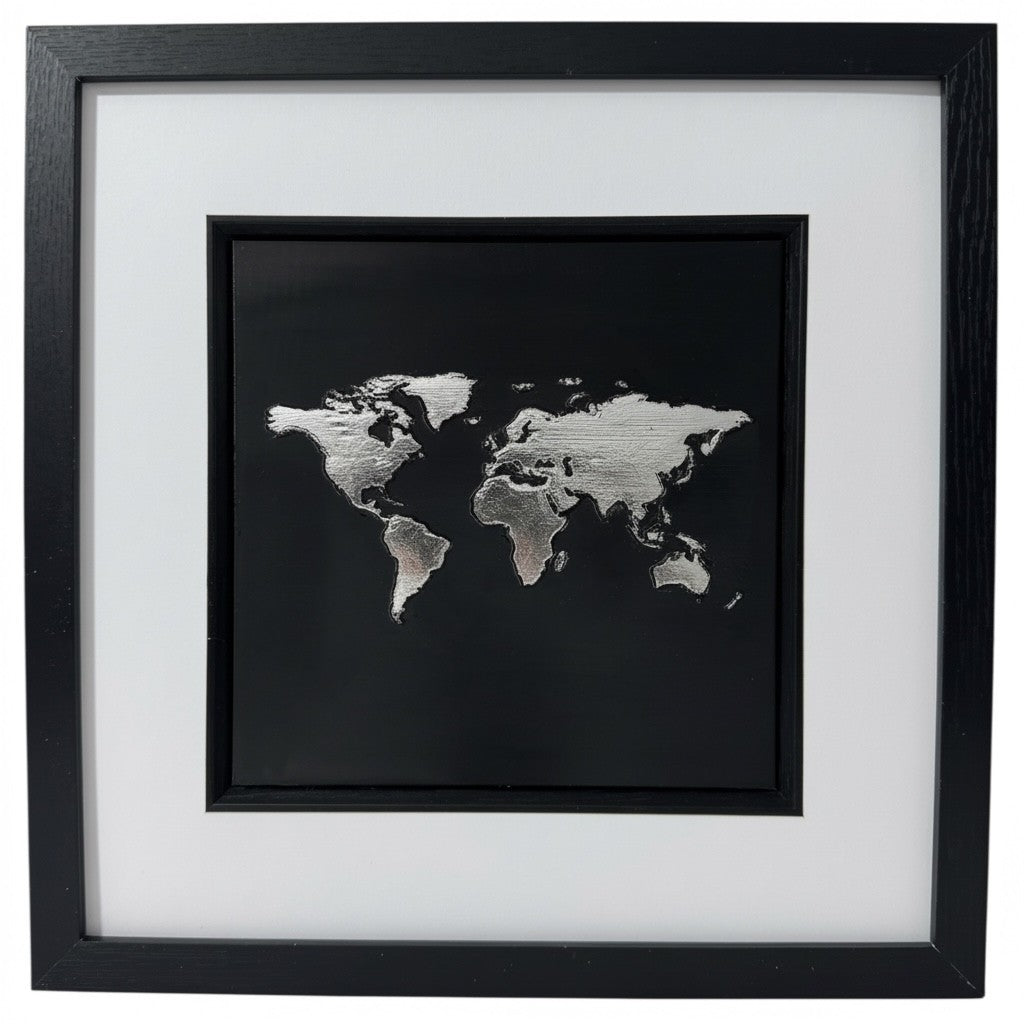 Silver metallic leaf World Map 3D wall art. High contrast chrome finish on black background in black box frame. Modern monochrome office decor.