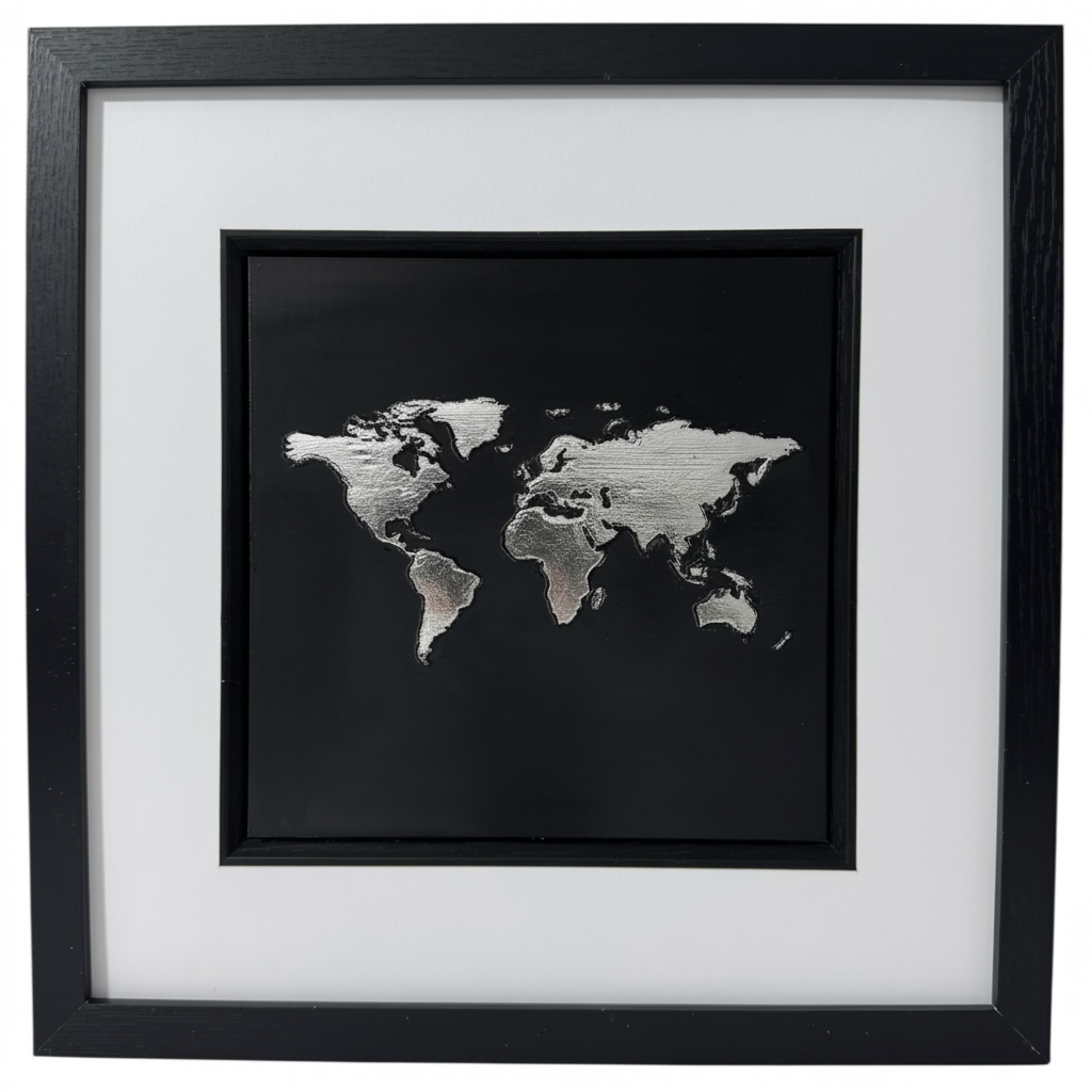 Silver metallic leaf World Map 3D wall art. High contrast chrome finish on black background in black box frame. Modern monochrome office decor.